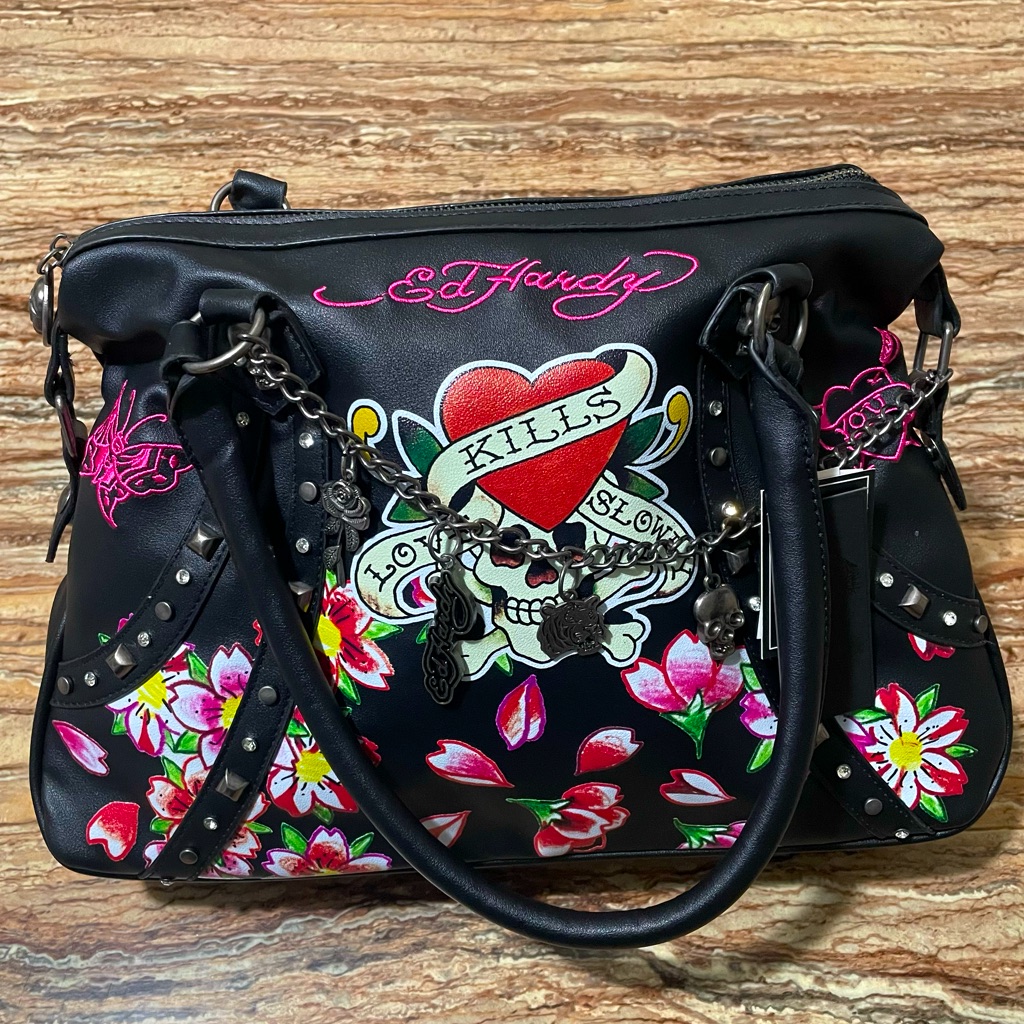 Ed Hardy handbag in black with a colour tattoo panel of a heart, dagger and roses, metal studs and a hanging charm
